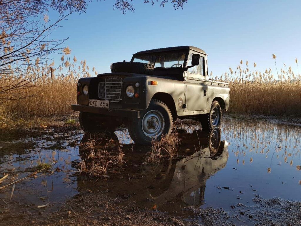 Old jeep parking in springy puddle